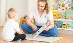 Montessori teacher speaking in an engaging manner with a child.